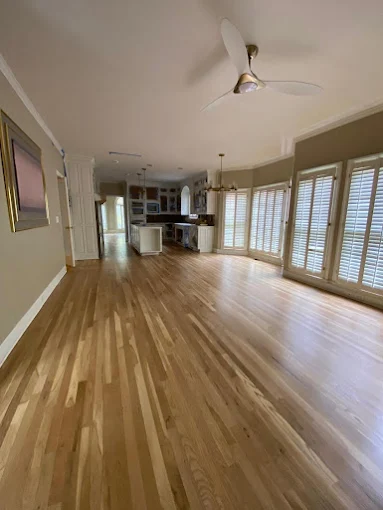 Refinished natural hardwood floors in open living room in Atlanta