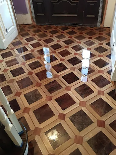 Refinished parquet hardwood floor with high-gloss finish