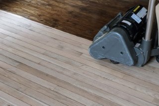 Hardwood floor being sanded in a home, showing the kind of room you would measure with this tool